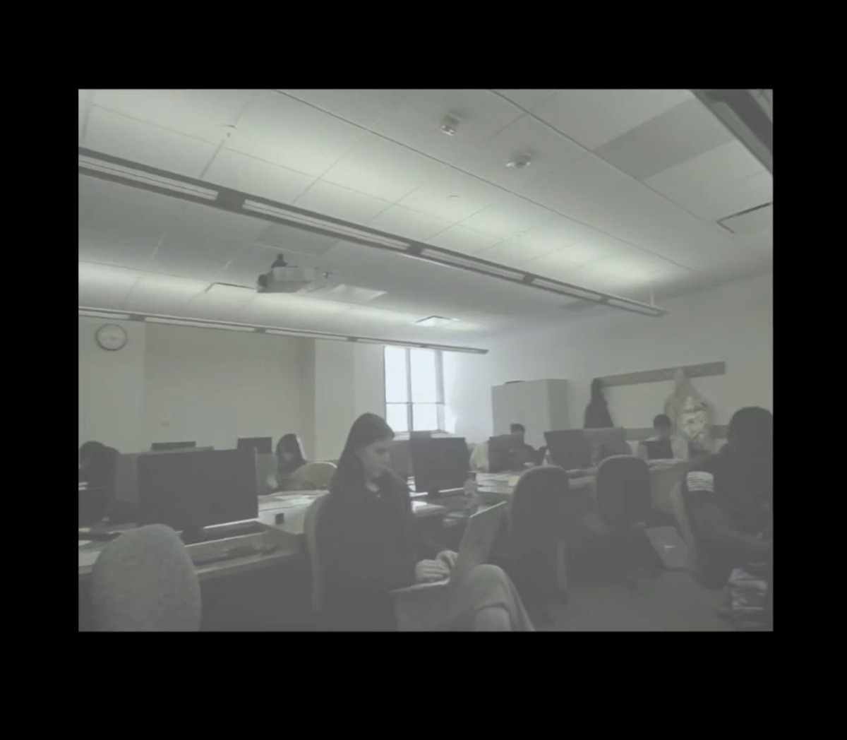 A classroom rendered in muted blues and yellows with reds washed out, simulating a dog's dichromatic vision.